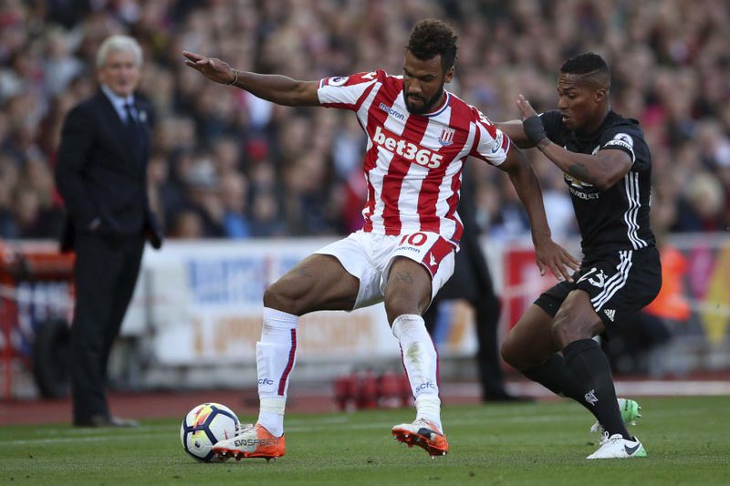 Stoke Cityu2019s Eric Maxim Choupo-Moting, (left), and Manchester Unitedu2019s Antonio Valencia battle for the ball during the English Premier League soccer match at the bet365 Stadium, Stoke, England, on Saturday, September 9, 2017. Photo: Nick Potts/PA via AP