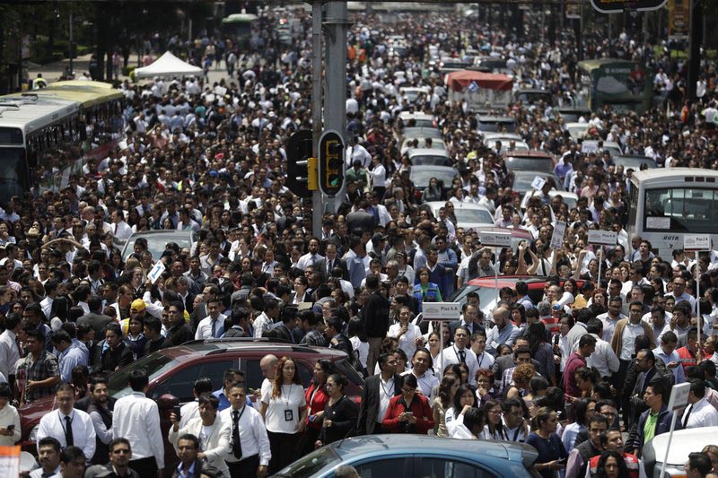 People evacuated from office buildings gather in Reforma Avenue after an earthquake in Mexico City, on Tuesday September 19, 2017. Photo: AP