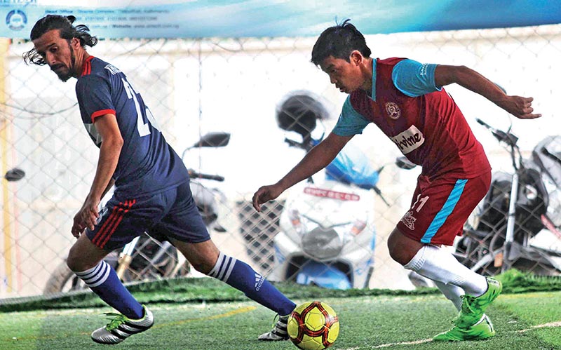 Ashish Lama (right) of Dvine Boys Futsal and Niresh Dulal of Khumaltar Youth Club vie for the ball during their National Futsal League match in Kathmandu on Friday. Photo: Udipt Singh Chhetry/ THT