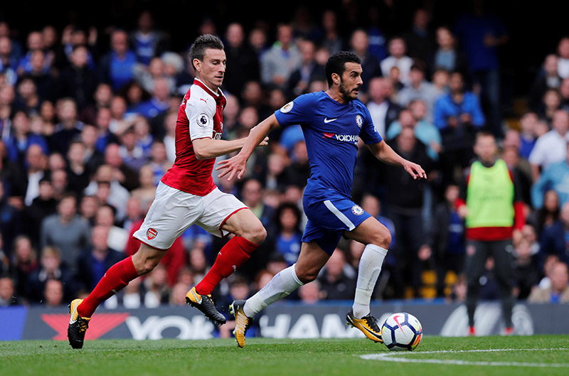 Chelsea's Pedro in action with Arsenal's Laurent Koscielny. Photo: Reuters