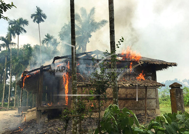FILE - In this Sept. 7, 2017 file photo, flames engulf a house in Gawdu Zara village, northern Rakhine state, Myanmar. Photo: AP