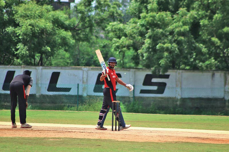 Nepalu2019s Sharad Vesawkar raises his bat after scoring a century against u2018Au2019 team of Tamil Nadu in India on Saturday.