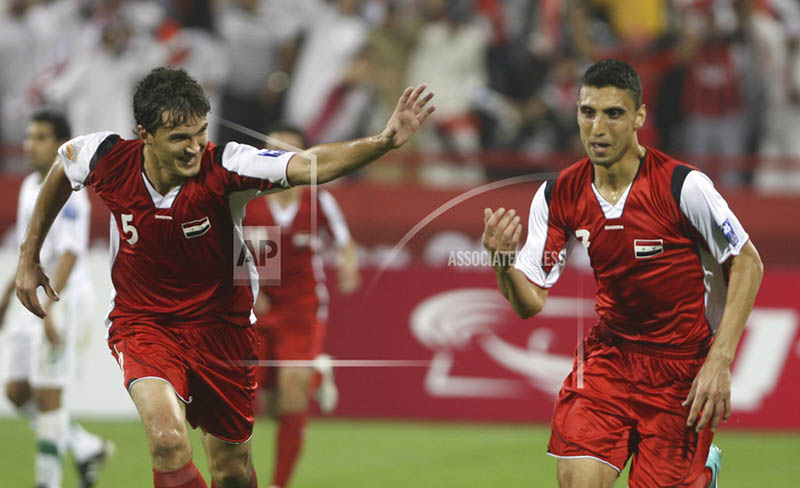 FILE - In this Jan. 9, 2011 file photo, Syria's midfielder Abulrazaq al-Hussein, left, celebrates with teammates after scoring his team's second goal against Saudi Arabia during their 2011 Asian Cup group B football match at Al-Rayyan Stadium in the Qatari capital Doha. Photo: AP