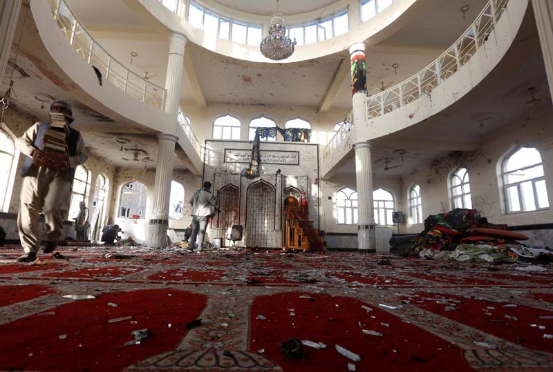 Afghan men inspect inside a Shi'ite Muslim mosque after last night's attack in Kabul, Afghanistan, on October 21, 2017. Photo: Reuters