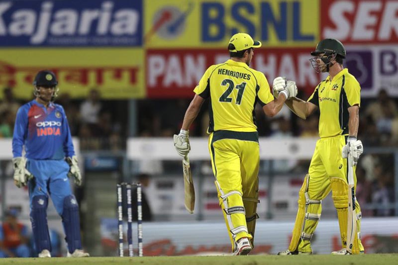Australiau2019s Moises Henriques (centre), greets his teammate Travis Head after scoring fifty runs during the second Twenty20 cricket match against India in Gauhati, India, on Tuesday, October 10, 2017.