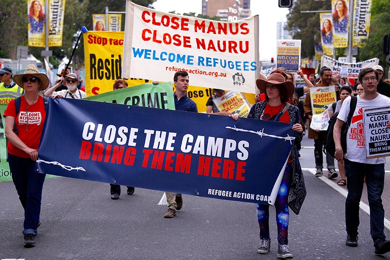 Refugee advocates hold placards as they participate in a protest in central Sydney, against the treatment of asylum-seekers in detention centres located in Nauru and on Manus Island, Australia, on October 15, 2017.  Photo: Reuters
