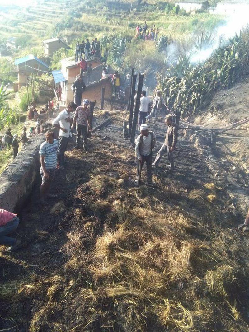 People gather and examine the houses gutted in the fire in Jukot, Swamikartik Rural Municipality-3 of Bajura district, on Tuesday, October 10, 2017. Photo: Prakash Singh/THT