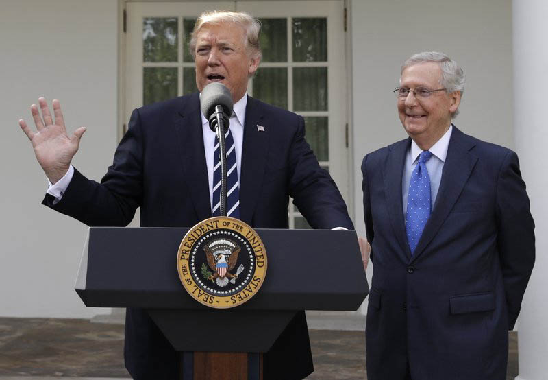 President Donald Trump answers questions with Senate Majority Leader Mitch McConnell, R-Ky., in the Rose Garden after their meeting at the White House, Monday, Oct 16, 2017, in Washington. Photo: AP