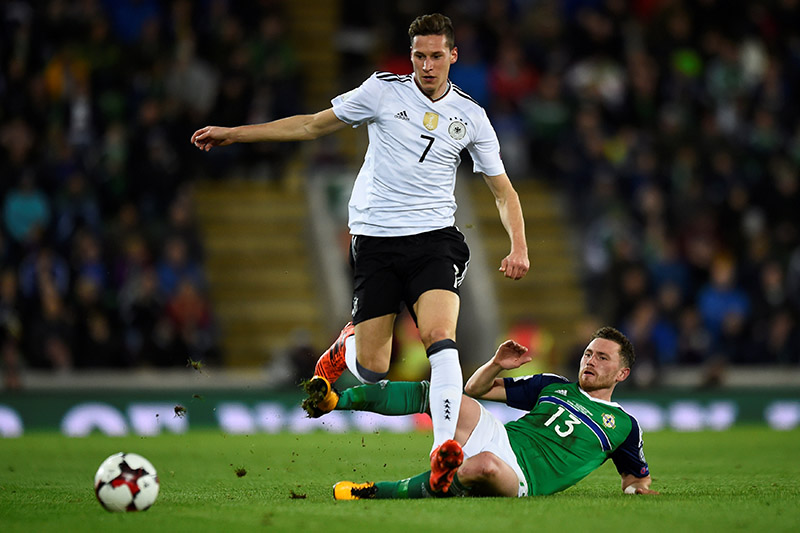 Germanyu2019s Julian Draxler in action with Northern Irelandu2019s Corry Evans. Photo: Reuters