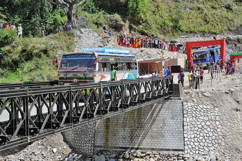 A passenger bus crosses local rivulet over belly bridge along Kaligandaki corridor at Jaimini Municipality-1 in Baglung district, on Wednesday, October 4, 2017. Photo: RSS