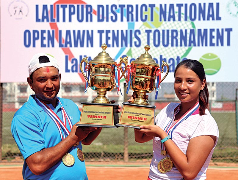 Kamal Bhandari and Mayanka Rana hold the trophies after the second Lalitpur Districtwide National Open Tennis Tournament in Lalitpur on Saturday. Photo: THT