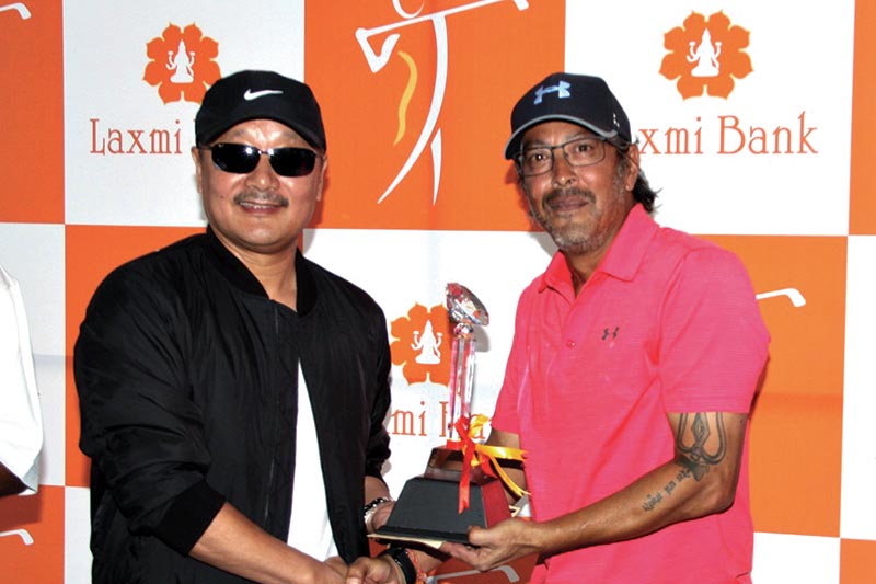 CEO of Laxmi Bank Sudesh Khaling handing over the trophy to Col Bikash Shah (right) after the Laxmi Bank Open Golf Tournament in Kathmandu on Saturday. Photo: THT