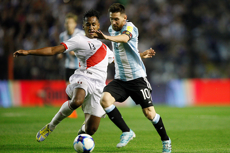 Lionel Messi of Argentina and Renato Tapia of Peru in action. Photo: Reuters