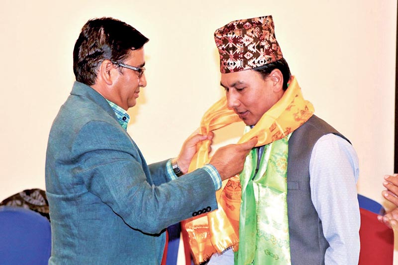 NOC President Jeevan Ram Shrestha (left) felicitates AIPS-Asia Treasurer Niranjan Rajbanshi at a programme in Kathmandu on Tuesday. Photo: THT