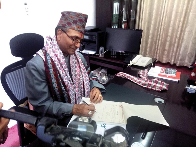 Newly-appointed CEO of National Reconstruction Authority Yubraj Bhusal assuming office, in Kathmandu, on Tuesday. Courtesy: NRA