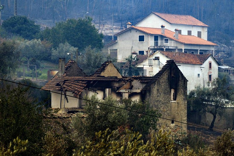A burnt house stands next to others that were spared by a wildfire near Penacova, northern Portugal, on Monday, October 16 2017. Photo: AP/ File