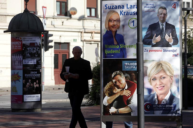 A man walks past presidential election campaign posters in Ljubljana, Slovenia, on October 19, 2017. Photo: Reuters