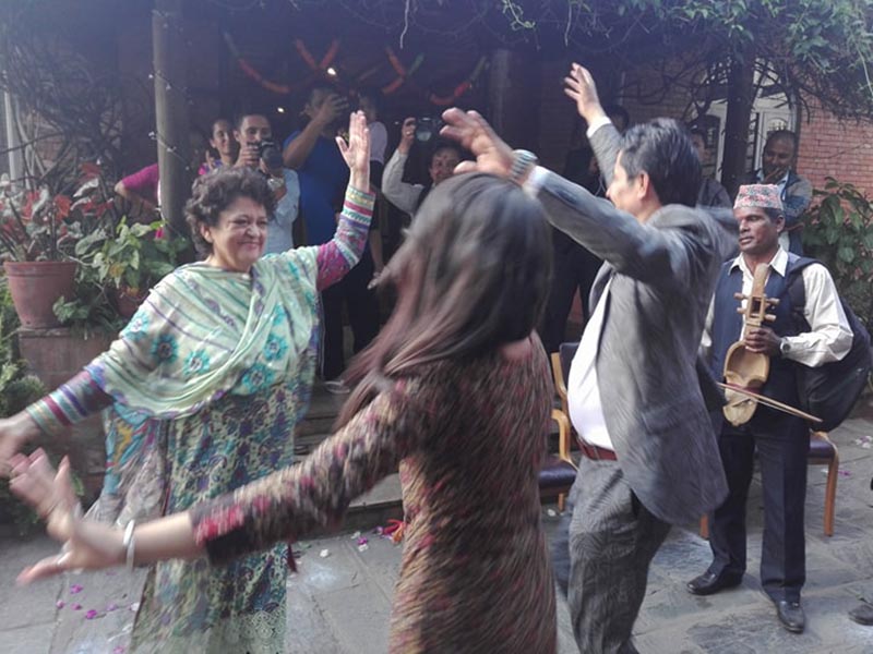 Former minister and Nepali Congress leader Sujata Koirala (left) performs dance in Deusi Bhailo programme organised by the Reporters' Club at Mandikhatar, Kathmandu, on the occasion of the Tihar festival, on Friday, October 20, 2017. Photo courtesy: Reporters Nepal