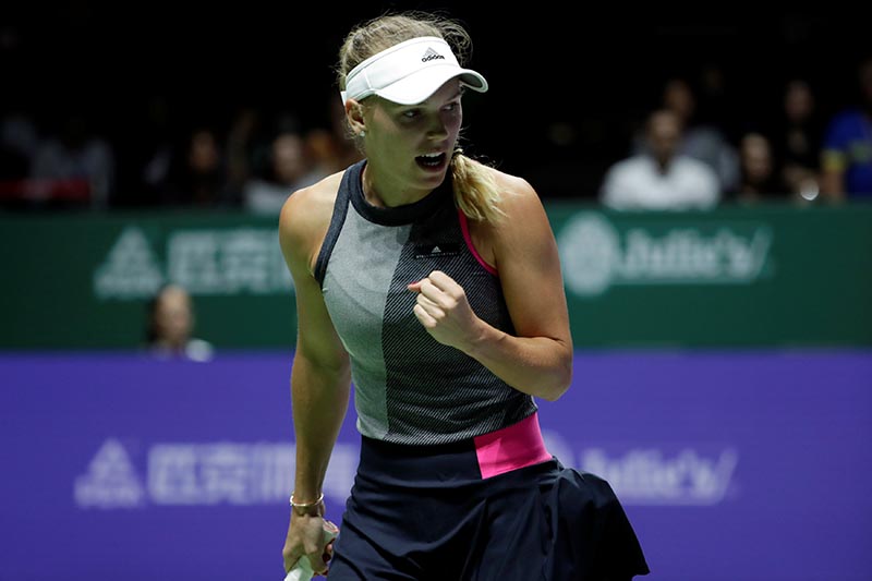 Denmark's Caroline Wozniacki celebrates during her group stage match with Ukraine's Elina Svitolina during the WTA Tour Finals match, at Singapore Indoor Stadium, in Singapore, on October 23, 2017. Photo: Reuters