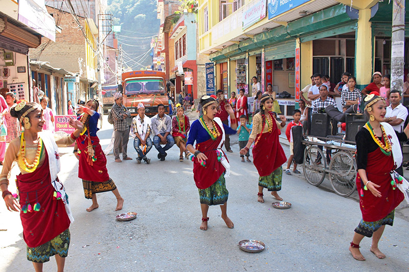 Locals obseve deusi-bhailo as local artists perfom dance during Tihar festival at Benni of Myagdi district, on Wednesday, October 18, 2017. Photo: RSS
