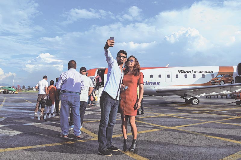Monika Shahi Nath (right), a transgender, and her husband Ramesh Nath Yogi taking a selfie before boarding an aircraft at Tribhuvan International Airport, in Kathmandu, on August 21, 2017. Photo: AFP