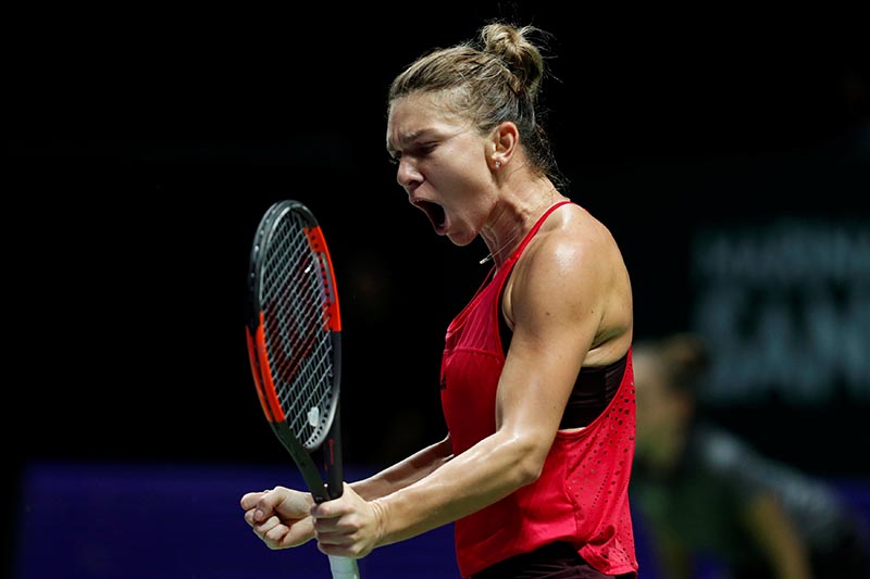 Romania's Simona Halep celebrates during her group stage match with France's Caroline Garcia during the WTA Tour Finals, at Singapore Indoor Stadium, in Singapore, on October 23, 2017. Photo: Reuters
