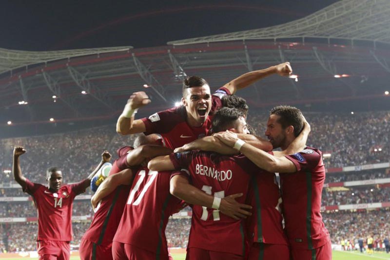 Portugalu2019s Pepe (top), celebrates with his teammates their sideu2019s second goal during the World Cup Group B qualifying soccer match between Portugal and Switzerland at the Luz stadium in Lisbon, on Tuesday, October 10, 2017. Photo: AP