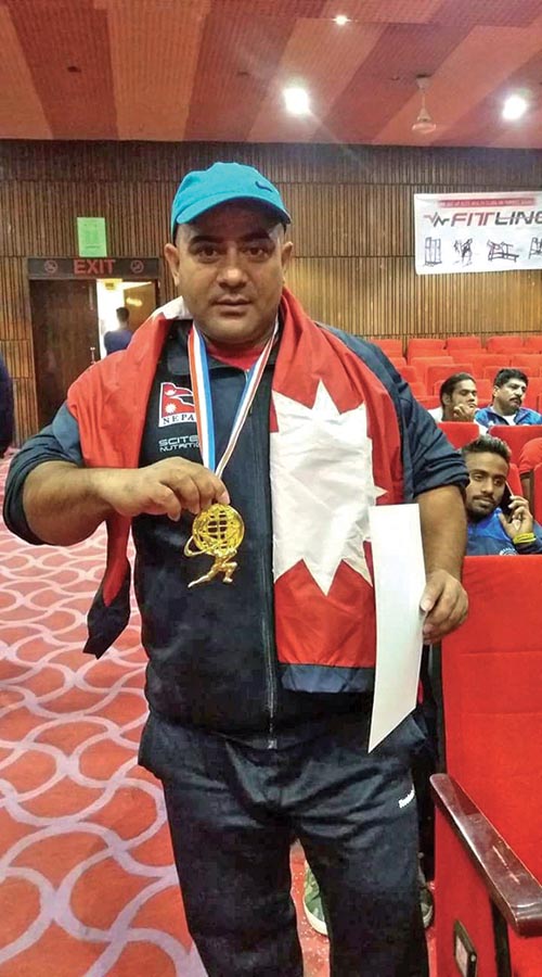 Nepalu2019s Buddhi Jung Karki holds the gold medal after the World Powerlifting Championship in India on Saturday.  Photo: THT