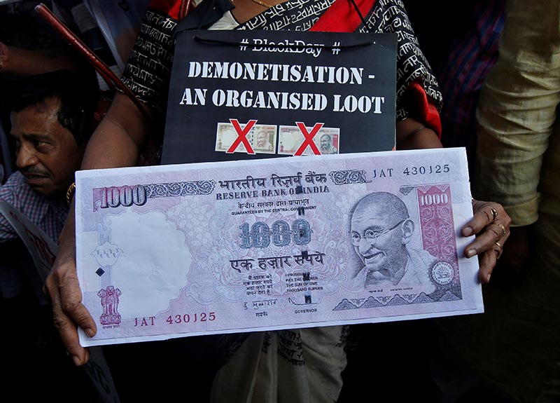 A demonstrator holds a replica of an abolished 1000 ruppee note during a protest, organised by India's main opposition Congress party, to mark a year since demonetisation was implemented by Prime Minister Narendra Modi, in Kolkata, India, on Wednesday, November 8, 2017. Photo: Reuters