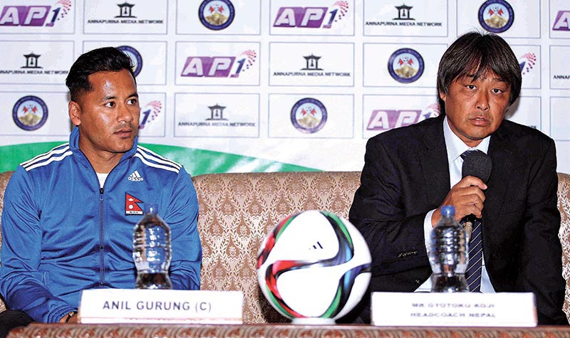 Nepal national football team head coach Koji Gyotoku speaks as skipper Anil Gurung looks on during a press meet in Lalitpur on Monday. Photo: THT