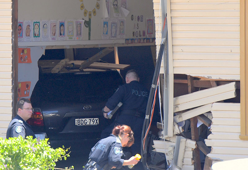 New South Wales emergency services personnel and police inspect a vehicle that crashed into a primary school classroom in the Sydney suburb of Greenacre in Australia, on November 7, 2017. Photo: AAP/Dean Lewins via Reuters