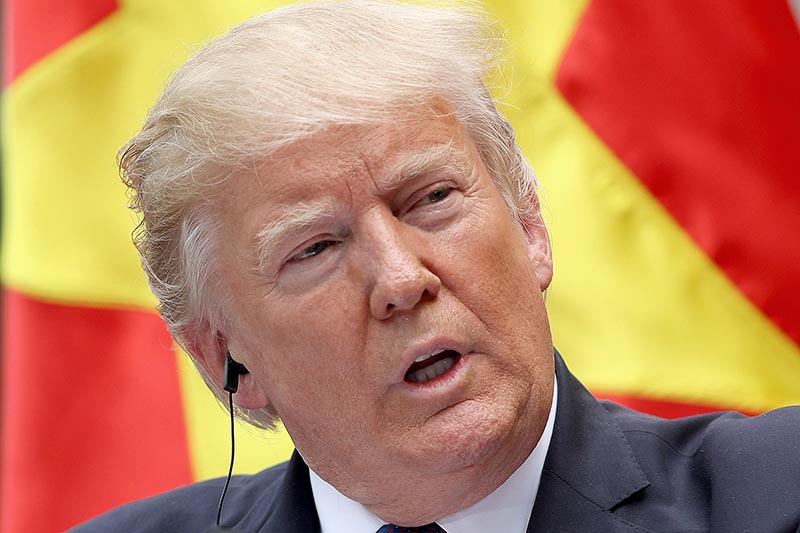 US President Donald J Trump (left) listens as his Vietnamese counterpart Tran Dai Quang (right) speaks during a press conference at the Presidential Palace in Hanoi, Vietnam, on 12 November 2017.  Photo: Reuters