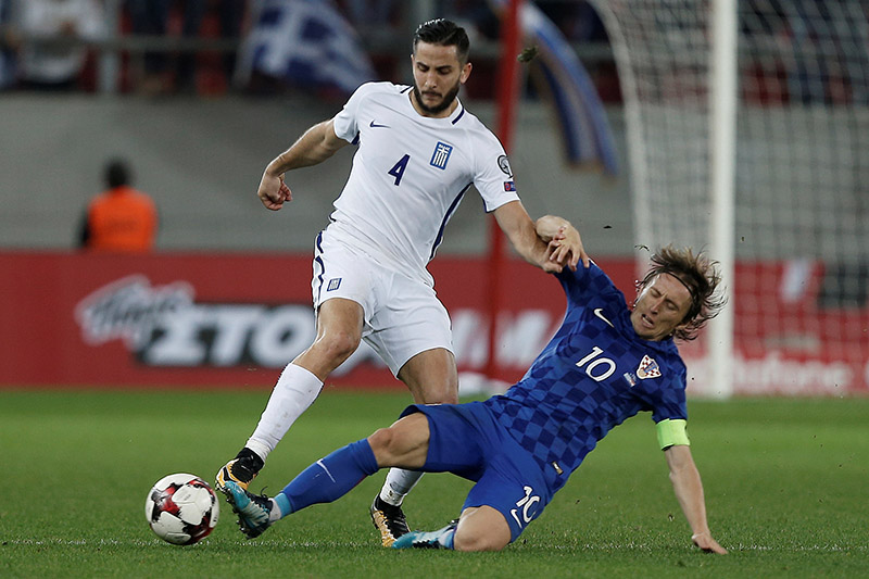 Greece's Panagiotis Retsos in action with Croatia's Luka Modric. Photo: Reuters