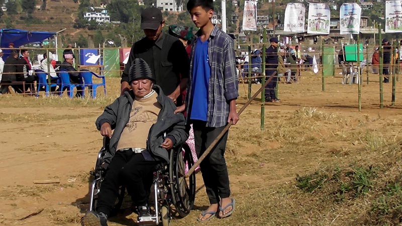 A disabled person is seen exiting the polling center after casting his vote in Phidim Municipality-1 of Panchthar district, on Sunday, November 26, 2017. Photo: Laxmi Gautam
