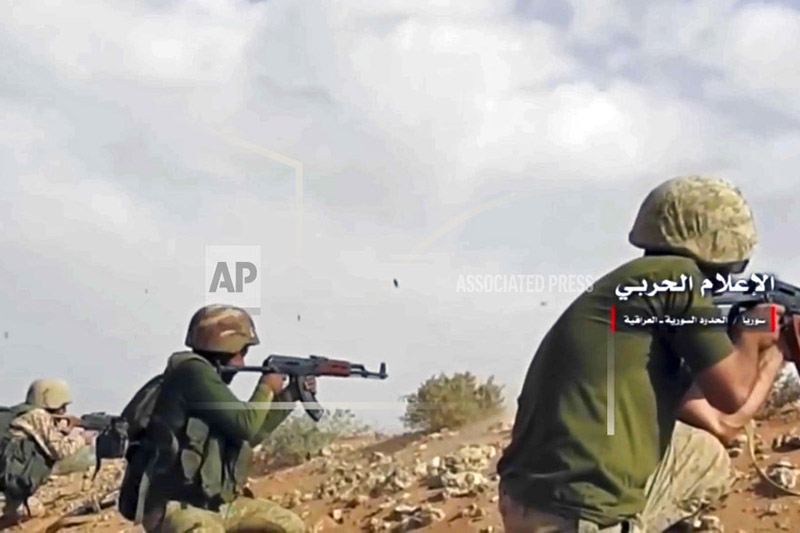 This frame grab from video provided Wednesday, Nov 8, 2017 by the government-controlled Syrian Central Military Media, shows Syrian pro-government troops taking up positions and firing on militants' positions on the Iraq-Syria border. Photo: AP