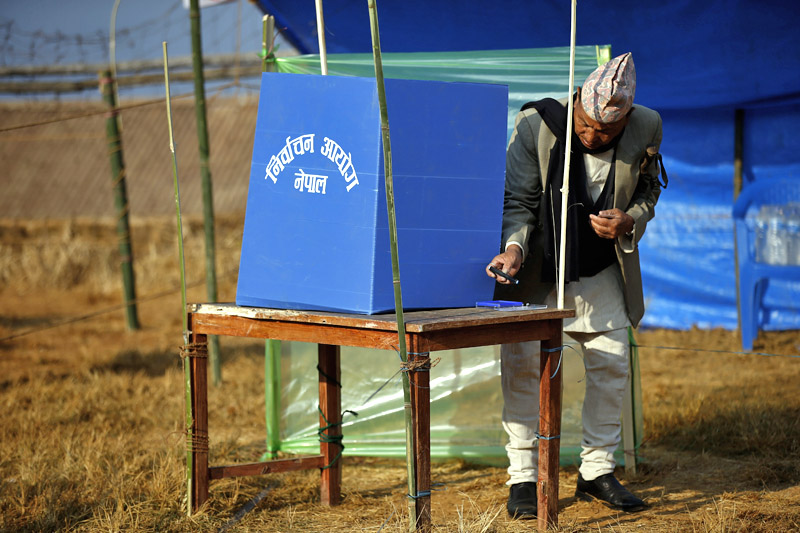 An elderly man casts his vote at a polling station in Phidim, Panchthar, under the first phase of the parliamentary and provincial elections, on Sunday, November 26, 2017. Photo: Skanda Gautam