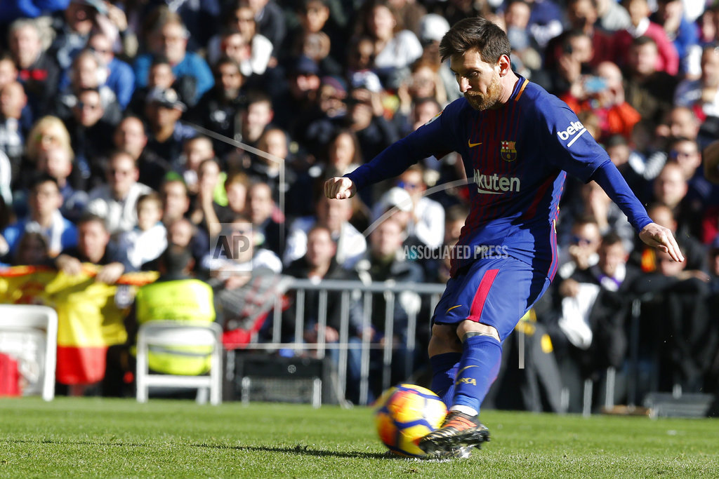 Barcelona's Lionel Messi scores from a penalty kick during a Spanish La Liga soccer match between Real Madrid and Barcelona at the Santiago Bernabeu stadium in Madrid, Spain, Saturday, Dec. 23, 2017. (AP Photo/Paul White)