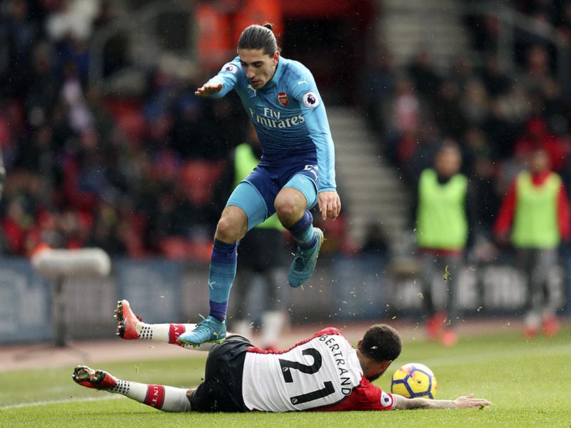Arsenal's Hector Bellerin (top), jumps over Southampton's Ryan Bertrand as they battle for the ball during the English Premier League soccer match at St Mary's Stadium, Southampton, England, on Sunday December 10, 2017. Photo: Adam Davy/PA via AP