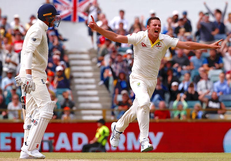 Australia's Josh Hazlewood celebrates after dismissing England's Craig Overton during the fifth day of the third Ashes cricket test match between Australia and England, at WACA Ground, in Perth, Australia, on December 18, 2017. Photo: Reuters
