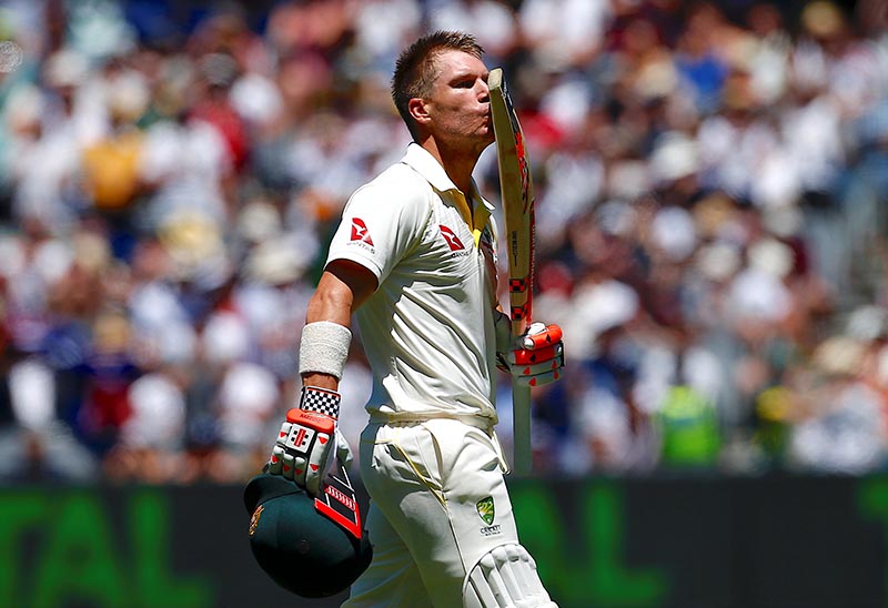 Australia's David Warner kisses his bat as he celebrates reaching his century during the first day of the fourth Ashes cricket test match between Australia and England, at MCG, Melbourne, Australia, on December 26, 2017. Photo: Reuters