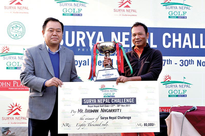 Marketing Manager of Surya Nepal Pvt Ltd Bal Kishan Gurung handing over the winneru2019s trophy to Bhuwan Nagarkoti (right) after the Surya Nepal Challenge at the Royal Nepal Golf Club in Kathmandu on Thursday. Photo: THT