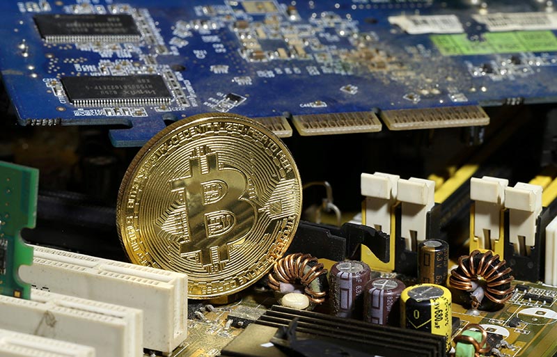 A copy of bitcoin standing on PC motherboard is seen in this illustration picture, on October 26, 2017. Photo: Reuters/ File