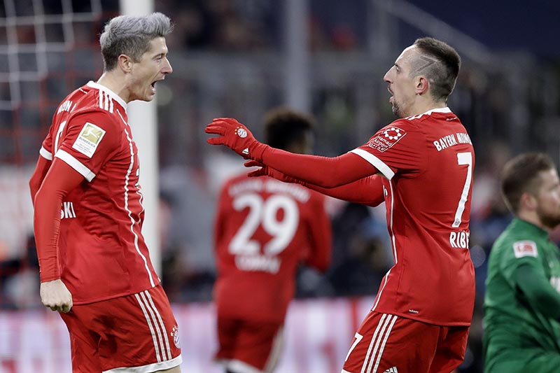 Bayern's Robert Lewandowski (left), celebrates with team mate Franck Ribery after scoring his side's opening goal during the German Soccer Bundesliga match between FC Bayern Munich and 1.FC Koeln in Munich, Germany, on Wednesday, December 13, 2017. Photo: AP