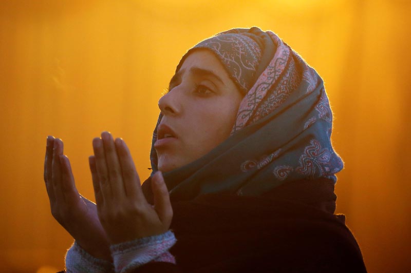 A woman prays during the festival of Eid-e-Milad-ul-Nabi, the birth anniversary of the Islamic prophet Mohammad, at Hazratbal shrine in Srinagar, on December 1, 2017. Photo: Reuters