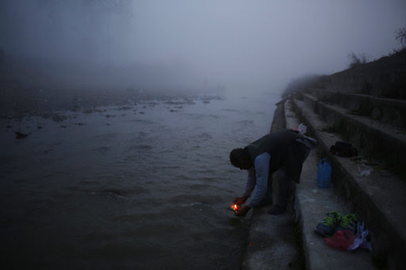 A Nepali devotee lights oil lamp during Gaya Aunshi festival in Kathmandu, on Monday, December 18, 2017. Photo: AP