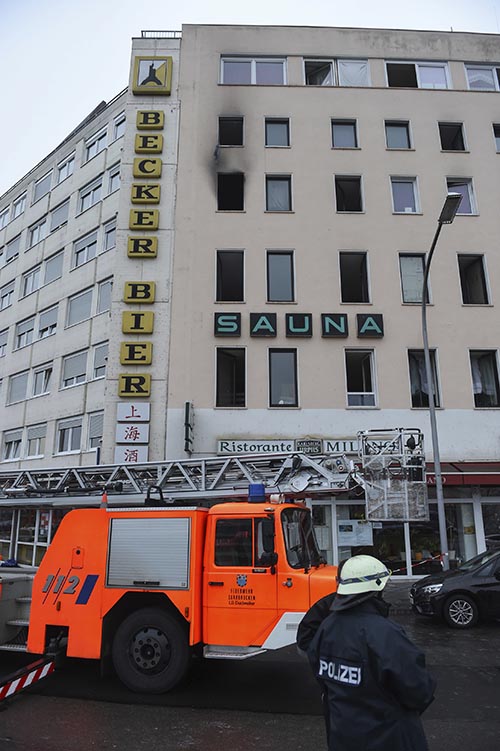 Firefighters are busy after a fire broke out in a multi-story building in Saarbruecken, western Germany, on Sunday, December 3, 2017. Photo: Oliver Dietze/dpa via AP