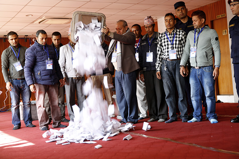 An Election Commission staff tosses ballot papers for counting,after the parliamentary and provincial elections in Kathmandu, on Friday, December 8, 2017. Photo: Skanda Gautam