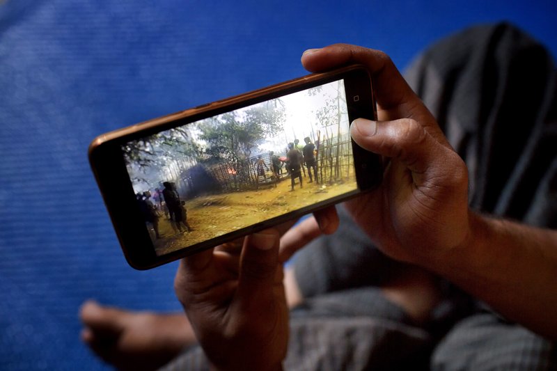 Mujibullah, 22, a Rohingya refugee watches a video, which he has shot in Myanmar before crossing over into Bangladesh, at Kutupalong refugee camp in Ukhiya, Bangladesh, on December 23, 2017. Photo: AP