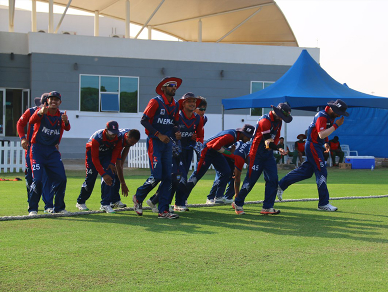 Nepal cricket team members enter the ground of field against Kenya during their practice match in Abu Dhabi, on Sunday. Photo Courtesy: Raman Shiwakoti