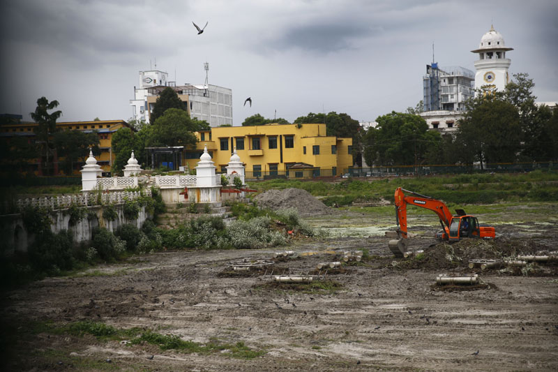 An excavator removes mud from historic Rani Pokhari that was damaged in 2015 earthquake and left intact till date in Kathmandu, Nepal on Tuesday, July 18, 2017. Photo: Skanda Gautam